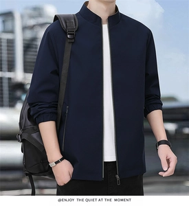 Detailed close-up of navy blue bomber jacket with stand collar and sleek metal zipper