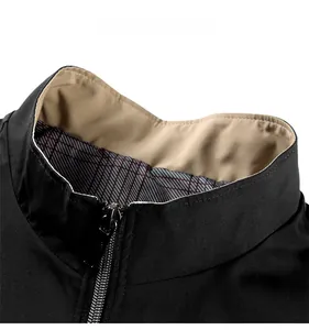 Detail of black stand-up collar jacket showing beige lining and metallic zipper