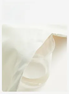 Macro shot demonstrating high breathability of white waterproof outdoor jacket fabric