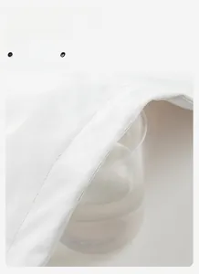 Detail of white jacket fabric demonstrating high breathability with steam passing through it