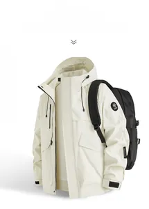 Close-up of a cream white waterproof outdoor jacket with adjustable hood and arm logo