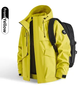 Detail view of yellow waterproof hiking jacket featuring functional black zippers and hood