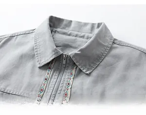 Detailed macro view of vintage cotton jacket collar with ethnic embroidered ribbon trim