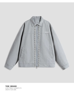 Close-up of vintage cotton jacket with ethnic woven trim and zipper closure detail