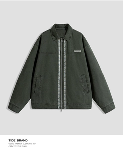 Detail of vintage green cotton jacket featuring ethnic woven tape and chest patch