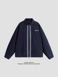 Navy blue vintage workwear jacket with embroidery and chest patch on flat lay view