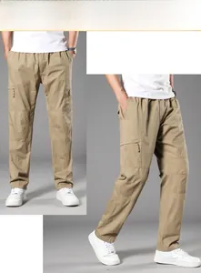 Detail view of khaki cotton cargo pants featuring large side pockets and straight-cut design
