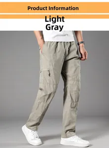 Detail view of light grey cotton cargo pants showing multi-pocket design and elastic waist