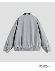 Rear view of grey worker jacket with black and white plaid collar and elastic hem