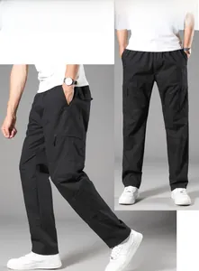 Detail view of men's black cargo pants with elastic waist and large side utility pockets