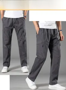 Detail of dark grey cargo pants featuring elastic waistband and side utility pockets