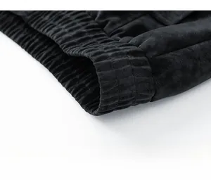 Close-up of the elastic ribbed hem on a vintage black washed PU leather bomber jacket