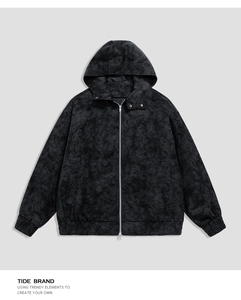 Close-up of vintage washed black PU leather jacket with hood and textured fabric detail