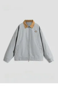 Detail of grey workwear jacket featuring a khaki collar and front zipper closure
