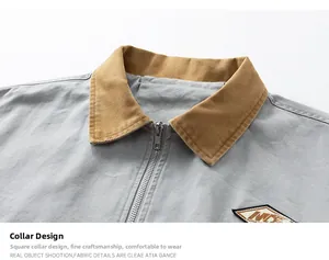 Detail of grey workwear jacket featuring khaki corduroy collar and metallic zipper