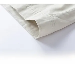Macro detail of multi-line stitching on the hem of a beige American retro jacket