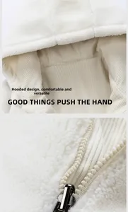 Detail of white sherpa fleece texture, striped lining, and metallic zipper on hoodie