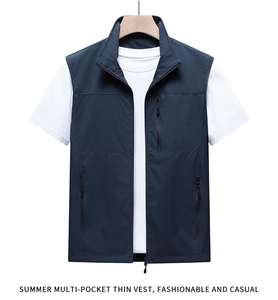 Detail of a dark blue functional multi-pocket vest with zipper on a wooden hanger