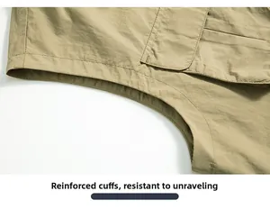 Macro shot of durable overlocked cuffs on a khaki fishing vest showing fabric texture