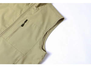 Detail of khaki outdoor vest showing breathable mesh lining and zippered utility pocket