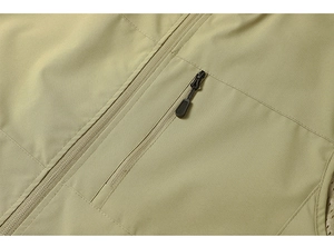 Macro shot of khaki outdoor vest showing zipper pocket detail and breathable mesh lining