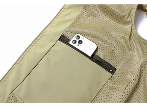 Detail view of khaki utility vest featuring breathable mesh lining and a hidden zipper pocket