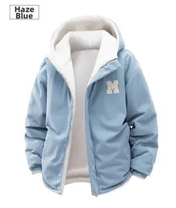 Close-up of winter fleece-lined blue corduroy jacket with white 'M' letter embroidery