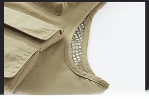 Detailed close-up showing double-stitched seams and breathable mesh on khaki utility vest