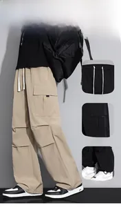 Detail of adjustable drawstring waistband and large side cargo pockets on trousers