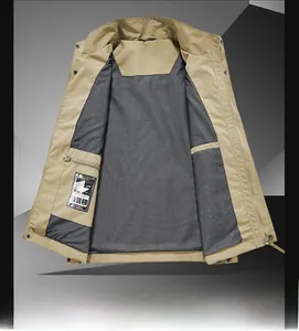 Detail view of khaki utility vest with breathable grey mesh lining and hidden inner pocket