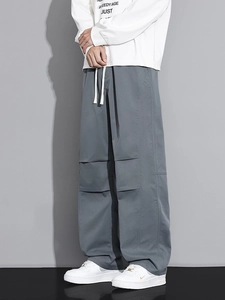 Men's grey wide-leg cargo pants with drawstring waist and knee pleats in street style