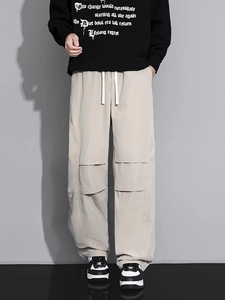 Men's khaki wide-leg cargo pants with drawstring waist and pleated knee detail