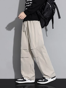 Men's loose cargo pants in khaki with drawstring waist and multi-pocket design details