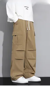 Detail view of khaki cargo pants featuring large side pockets and white waist drawstrings