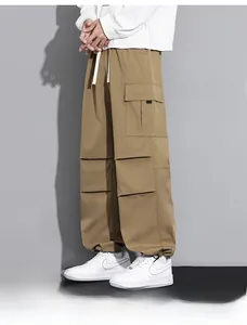 Detail of khaki cargo pants featuring elastic drawstring waist and large side flap pockets