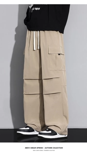 Detail view of khaki cargo pants featuring large side flap pockets and white drawstring