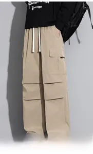 Detail shot of khaki cargo pants with drawstring waist and unique layered seam construction