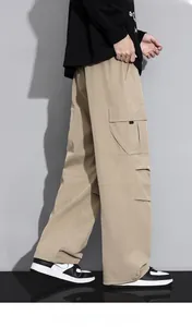 Detail view of khaki cargo pants with large side pockets and loose straight fit design
