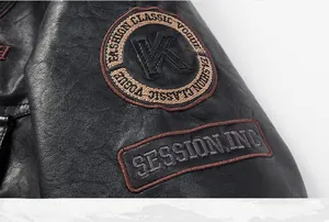 Detailed close-up of embroidered patches and litchi texture on a black faux leather jacket