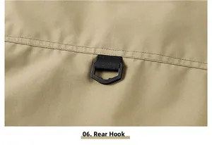 Close-up of khaki utility vest showing durable fabric and a black functional D-ring hook