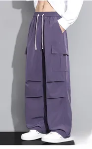 Detail of dark purple cargo pants with elastic drawstring waist and large utility pockets