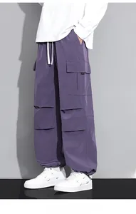 Detail of purple cargo pants showing large side pockets and adjustable drawstring hems