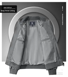 Detail view of water-resistant inner lining and ribbed cuffs on dark grey bomber jacket
