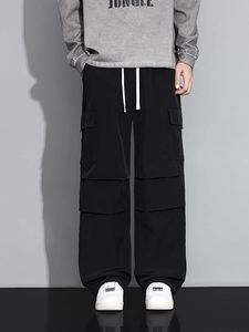 Men's loose black cargo pants with multiple pockets and white drawstring waist cord
