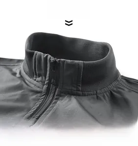 Detail of men's dark gray flight jacket featuring a ribbed knit stand collar and smooth zipper