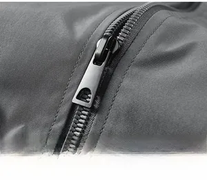 Detail of high-density twill fabric and matte black metal zipper on men's jacket