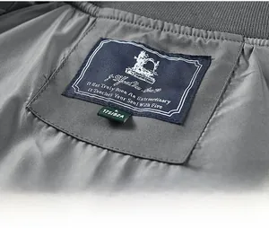 Macro view of neck label and size tag on men's gray casual utility bomber jacket