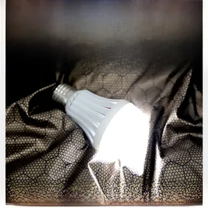 Detail of graphene fabric with hexagonal texture showing heating effect with LED bulb