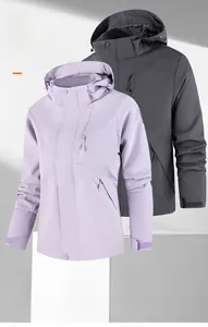 Detail of waterproof outdoor jacket showing adjustable velcro cuffs and zippered pockets
