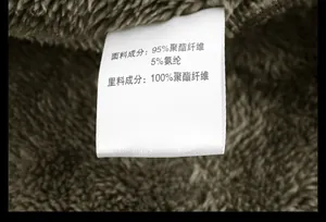 Detailed close-up of winter jacket inner lining texture and fabric care label info